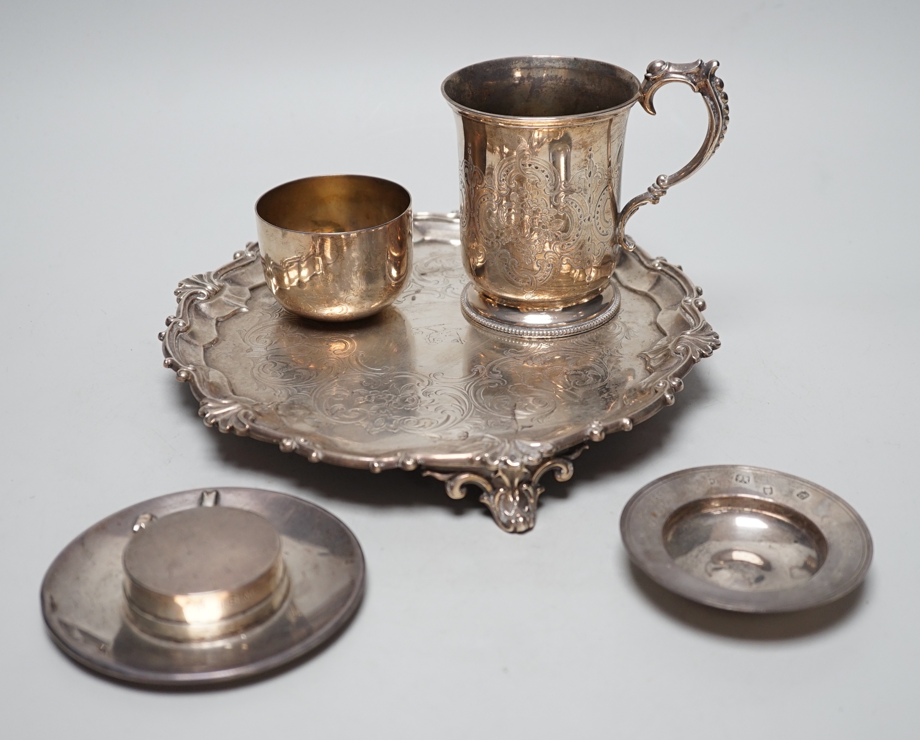 A Victorian silver salver, by The Barnards, London, 1847, 23.1cm, together with a chased silver christening cup, a presentation pin dish, a further novelty dish in the form of a bonnet and a George III silvetr tumbler cu